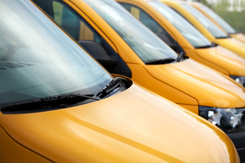 A fleet of yellow commercial vehicles.
