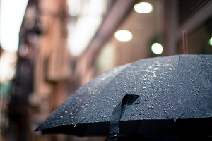 A black umbrella in the rain.